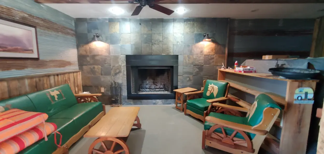 Cozy sitting area with a fireplace in the barn at Sidetrack RV Park